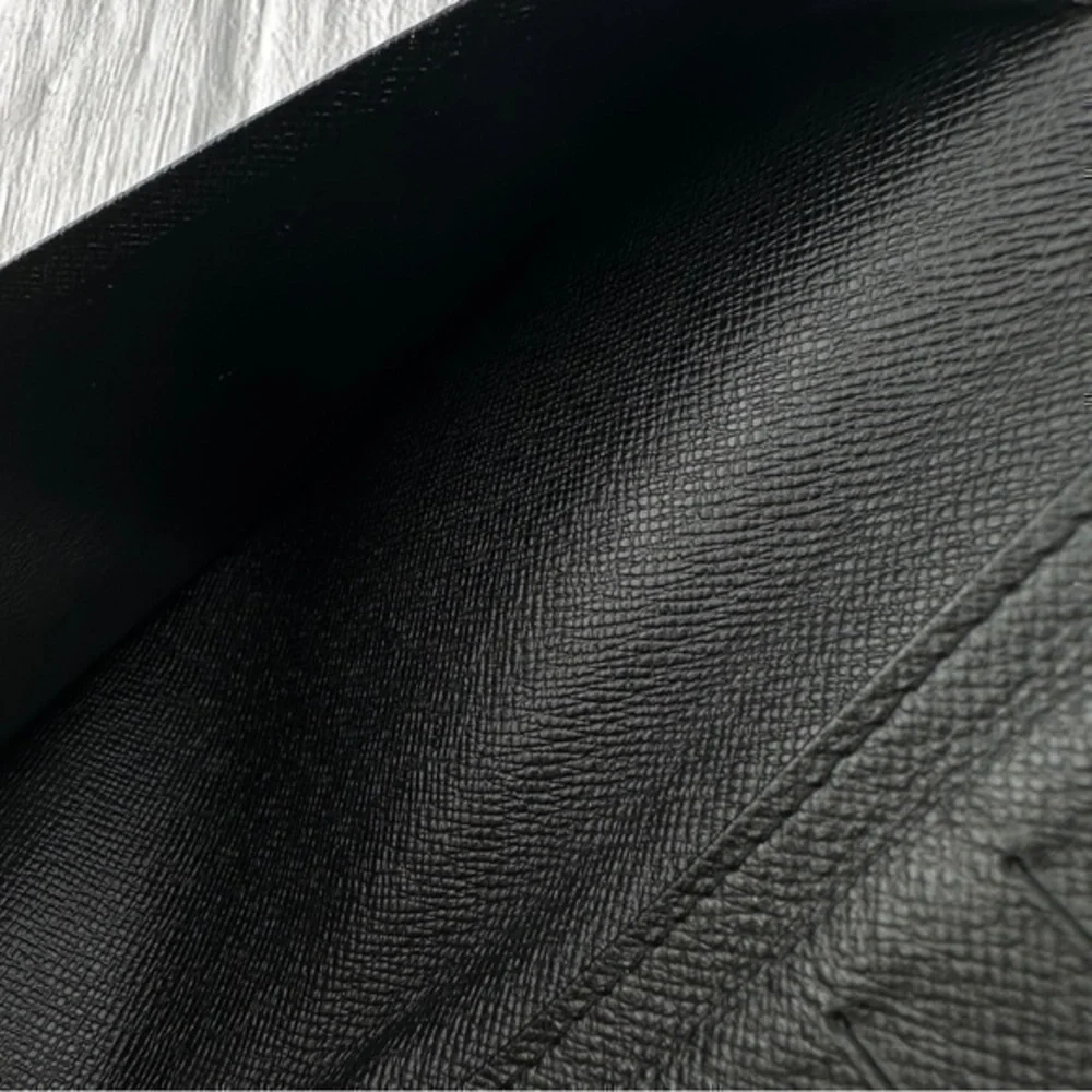 AUTHENTIC Louis Vuitton Taiga wallet. Previously owned. Color: Black.
